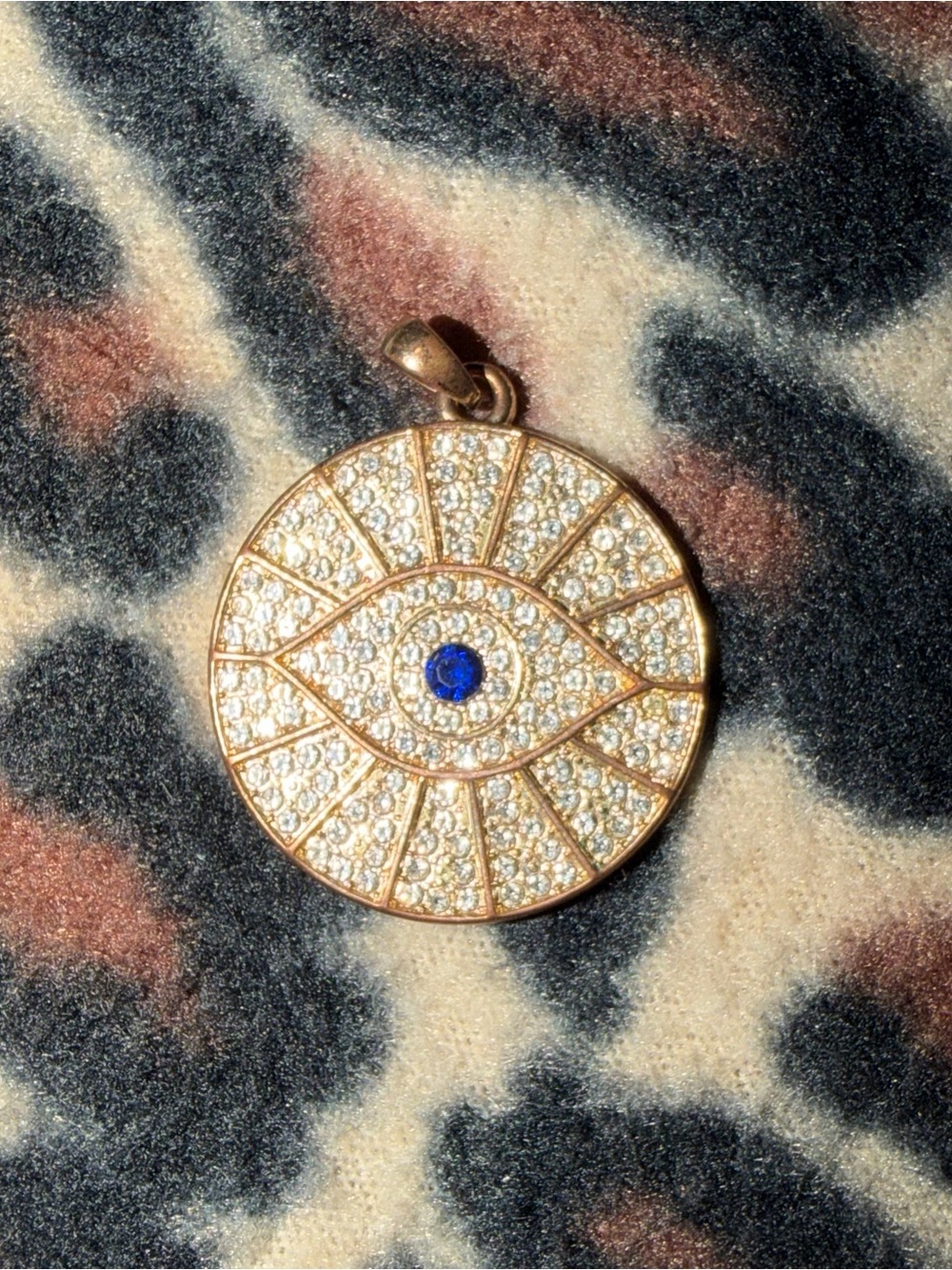 Eye of providence pendant with blue gemstone and diamond like stones